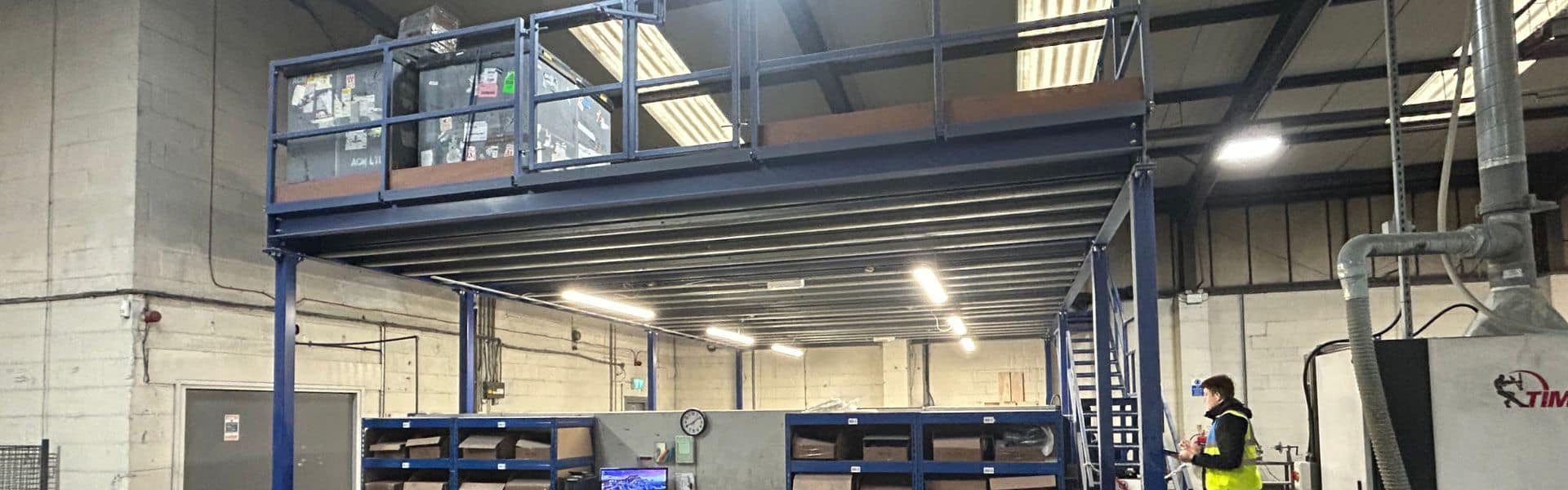 Mezzanine floor installation, steel column and beam construction with timber joists, industrial warehouse