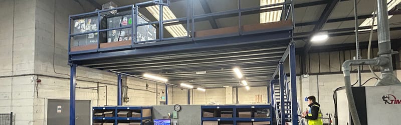 Mezzanine floor installation, steel column and beam construction with timber joists, industrial warehouse